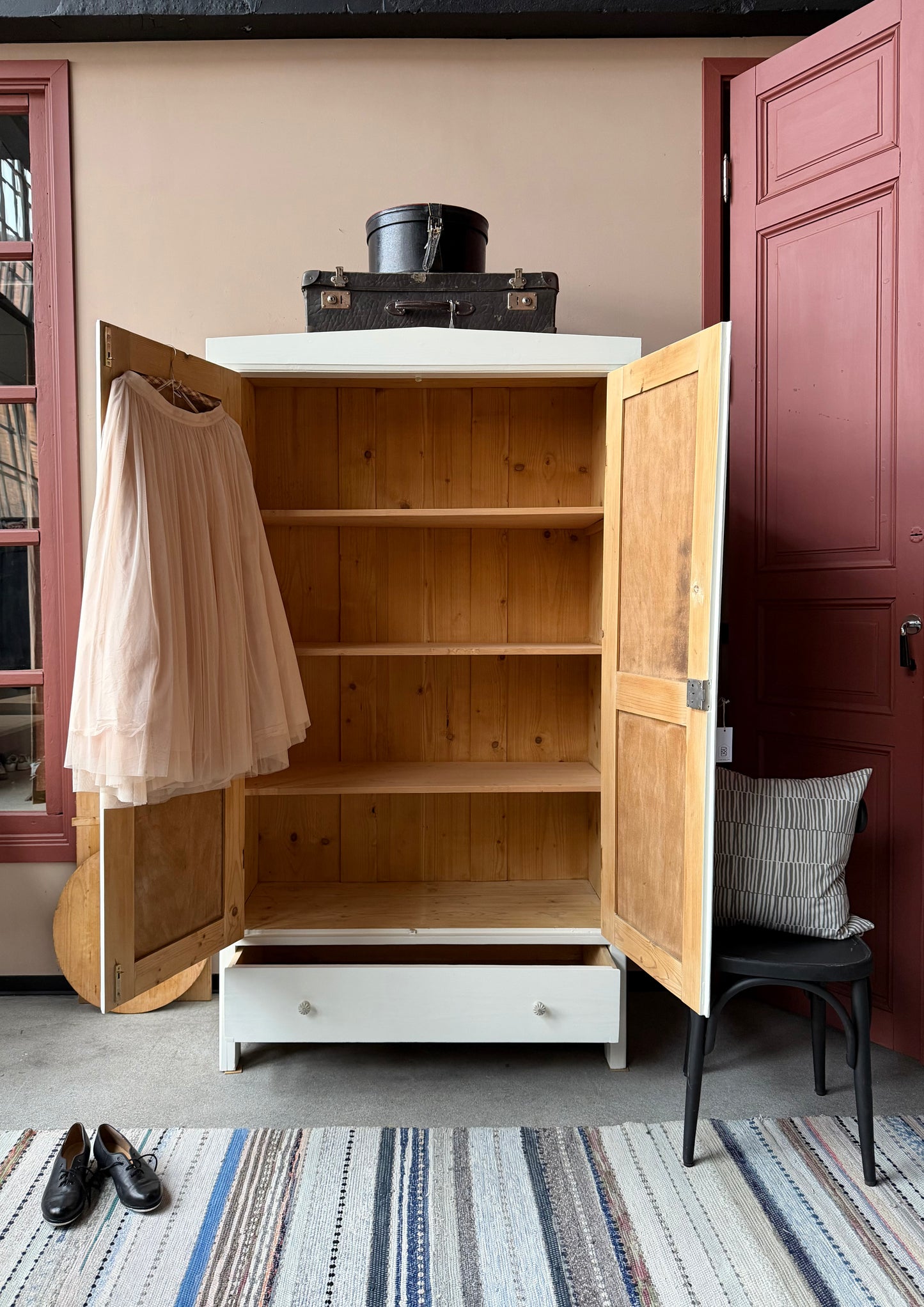 Ett gammalt vackert linneskåp med rundad form upptill och profilerade speglar.