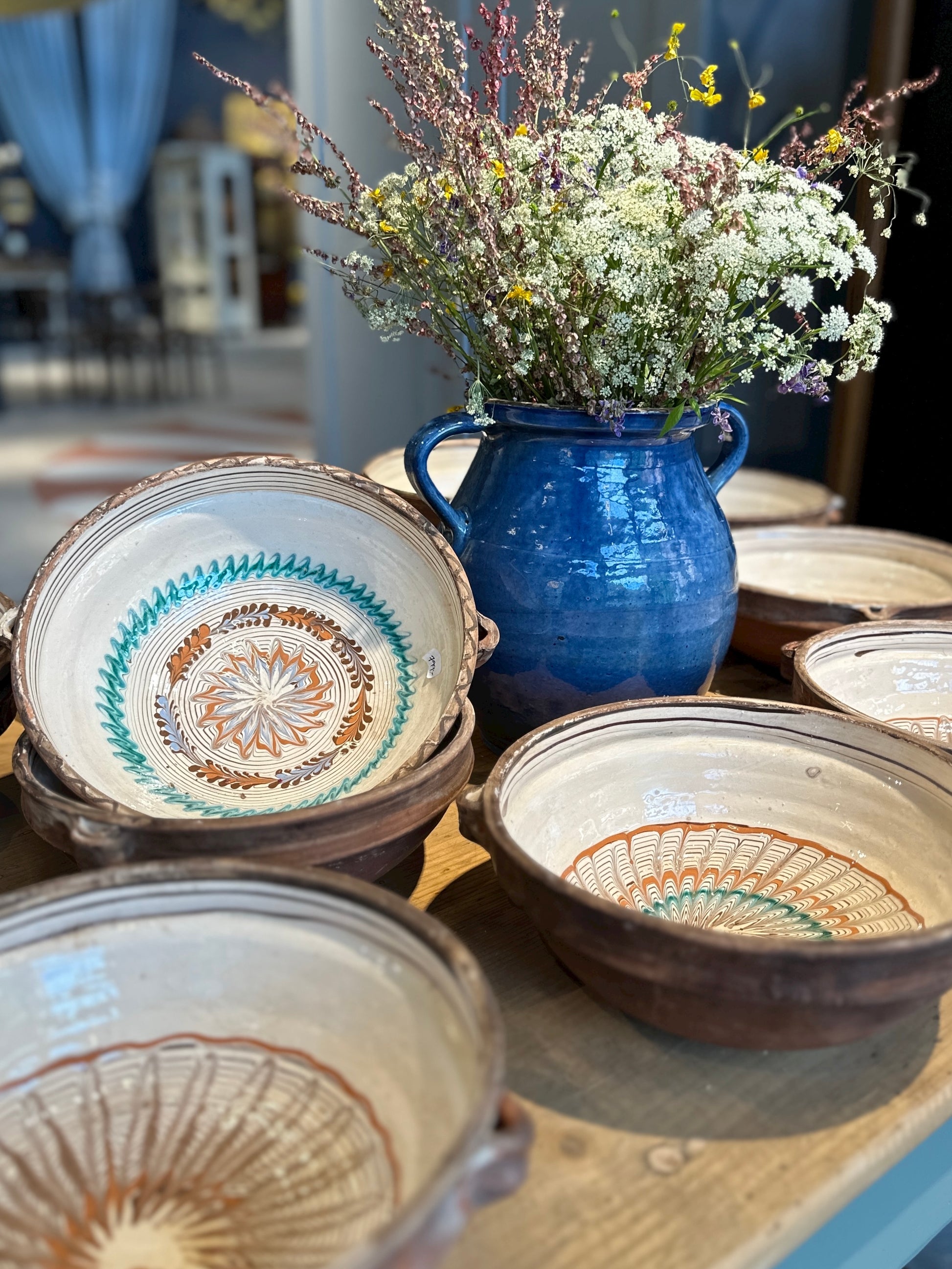 Keramikskålar på ett bord med en blomma i mitten.