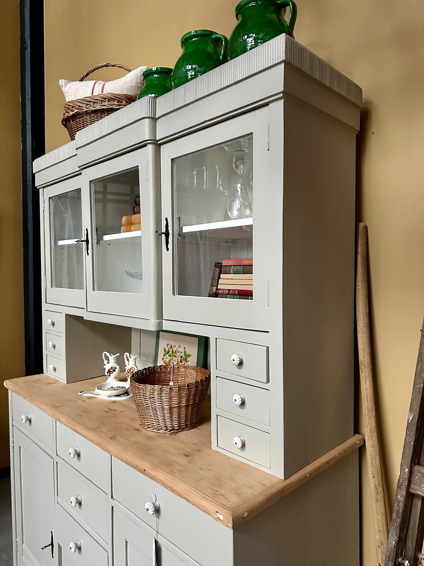 ljust köksskåp mot gul vägg