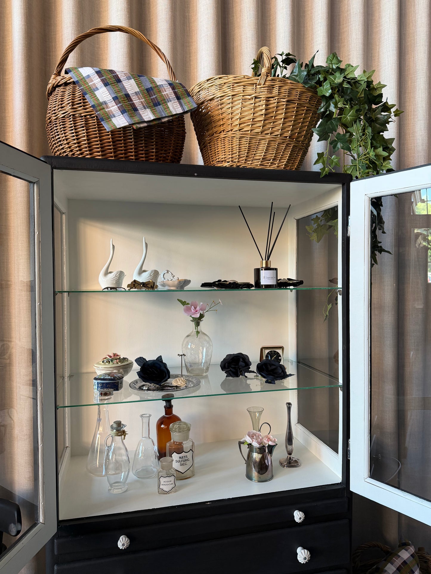 Ett gammalt läckert vitrinskåp/läkarskåp i trä med två hyllor i glas och även glas i sidan. Ett perfekt skåp för badrummet eller som vitrinskåp i kök eller vardagsrum. Skåpet har både en utdragbar skiva samt fina små lådor och skåp med dold förvaring nertill. Ett väldigt praktiskt skåp helt enkelt. 